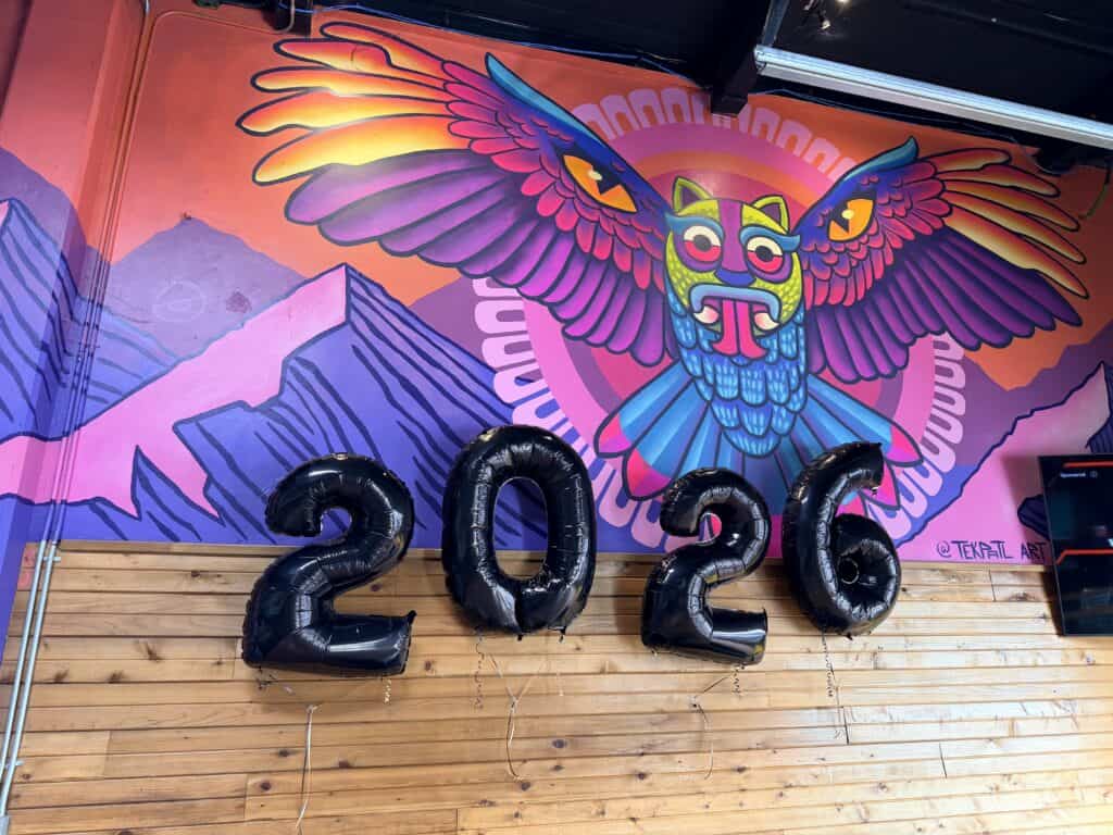 Xicha Brewing colorful owl mural with 2026 balloons in front