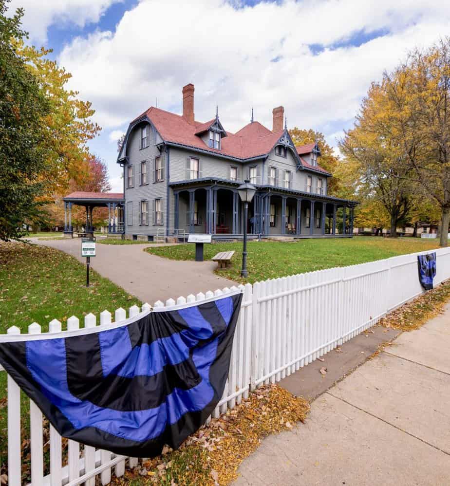 Black and blue bunting hangs on the fence in front of James A. Garfield National Historic Site.