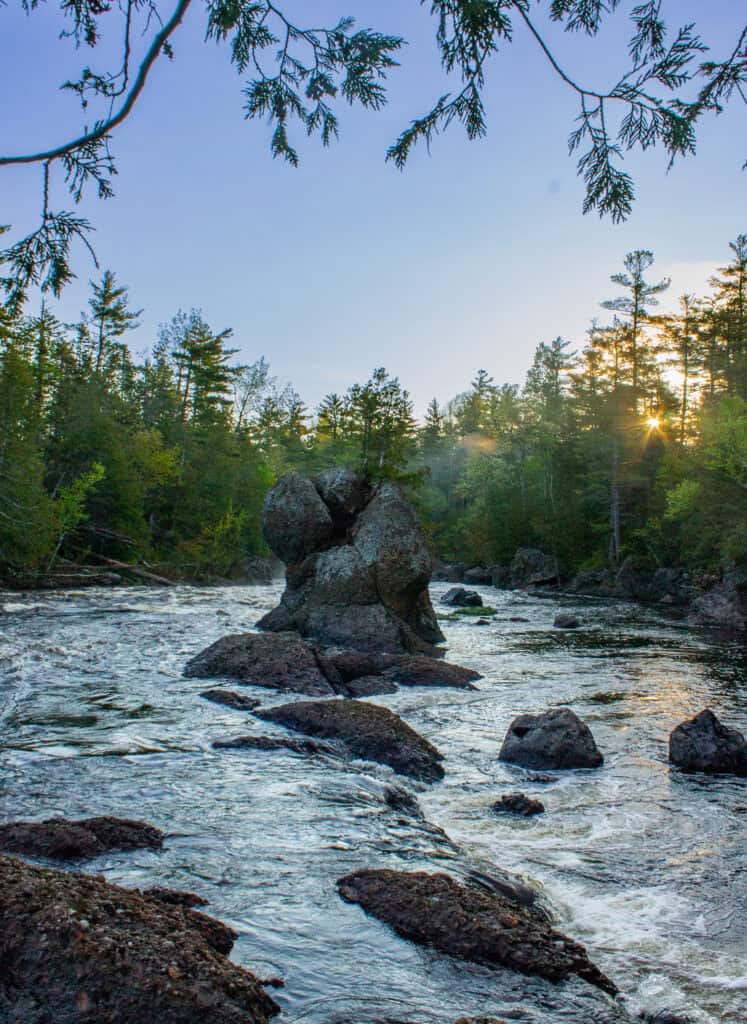 Water rushes through a wooded landscape at Kathadin Woods and Waters National Monument.