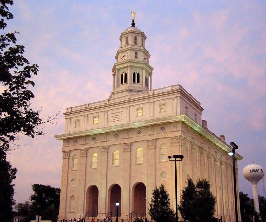 The historic Nauvoo Temple stands before a dusking sky. Nauvoo Temple is a key stop along the Mormon Pioneer National Historic Trail.