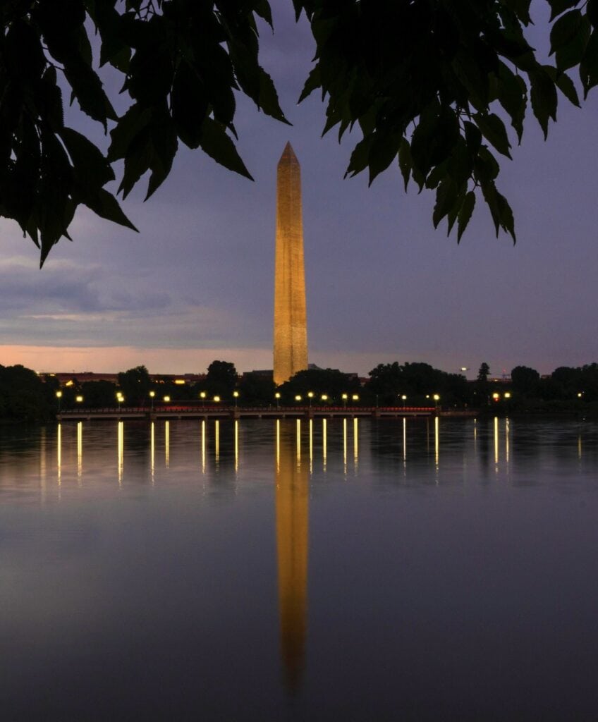 Calm waters reflect the Washington Monument near the National Mall.