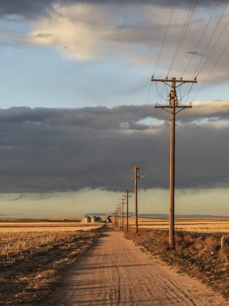 Evening sunlight guilds rural fields along Colorado's Pony Express National Historic Trail.
