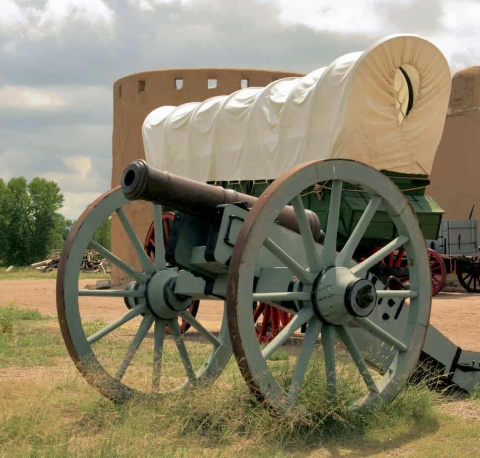 A wagon and cannon stand outside Bent's Old Fort along the Sante Fe National Historic Trail.