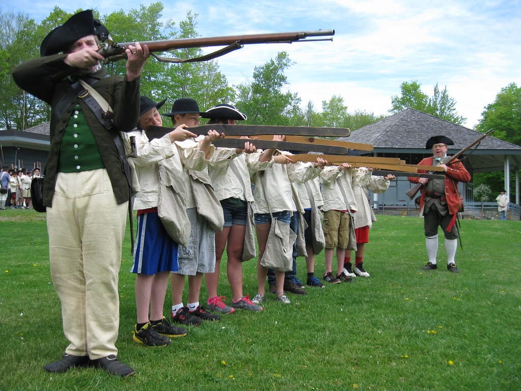 Children prepare for battle in a historical reenactment of marksmanship training.