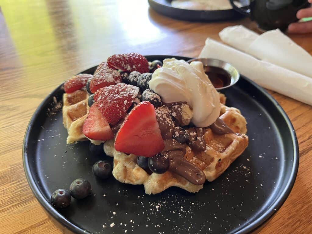 Liege waffles topped with Nutella and fresh strawberries and blueberries at Kickstand Coffee