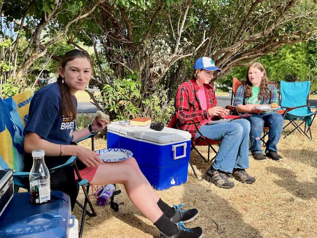 Our teen daughters having lunch at a campground