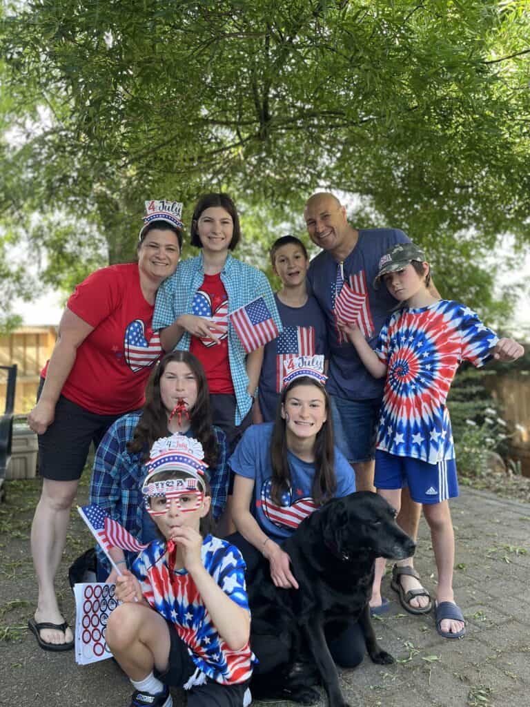 Warren family and dog in Fourth of July outfits. Dinkum Tribe is a neurodivergent family travel and lifestyle blog.