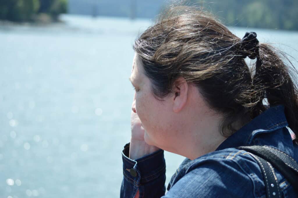 Jenn staring out at water