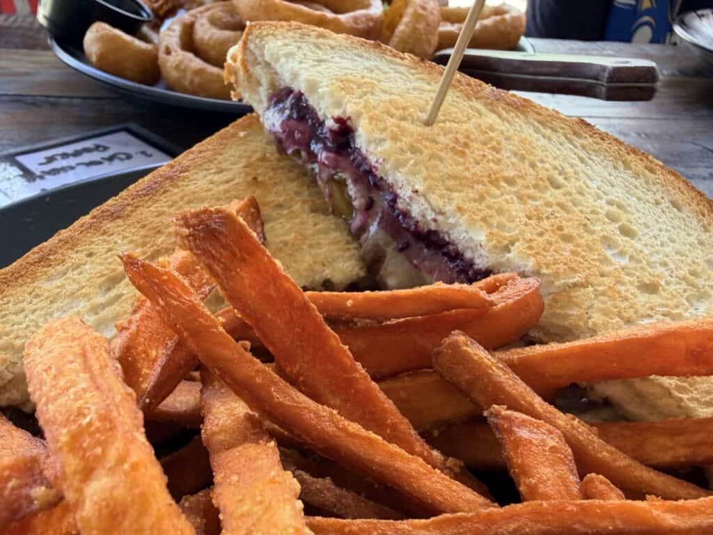 Blackberry grilled cheese with jalapeños served with sweet potato fries.