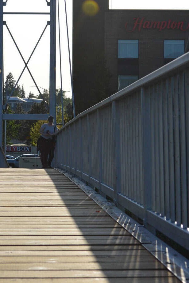 Pedestrian bridge with the Hampton Inn and Suites in the background