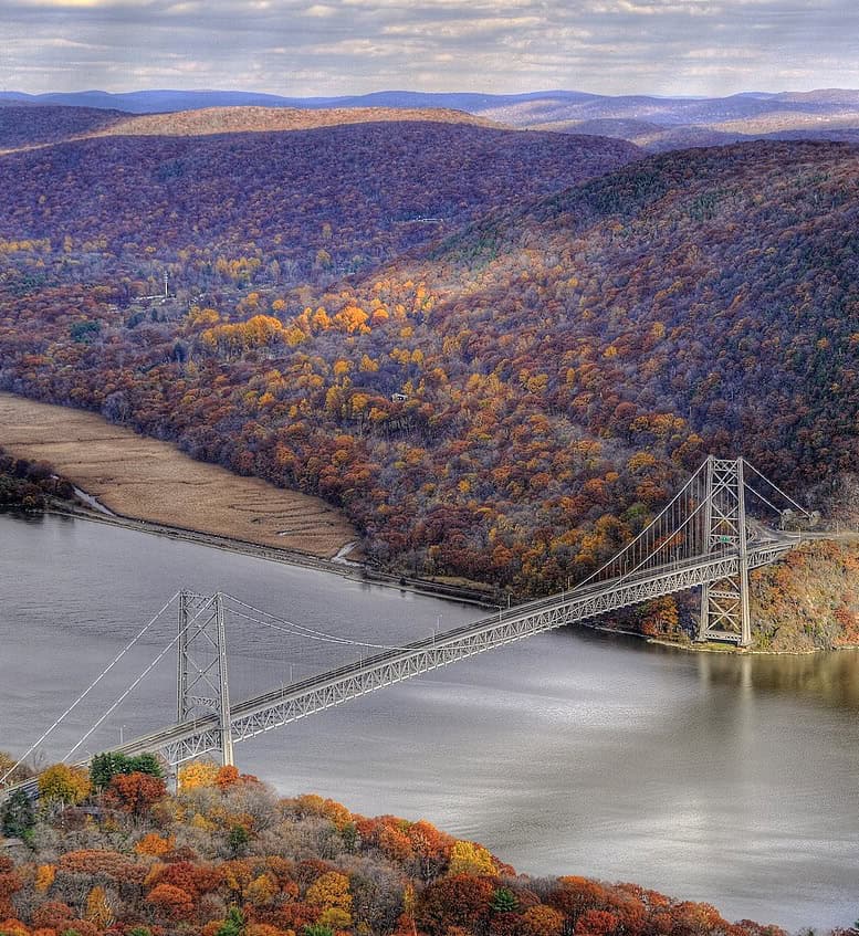 Fall colors drape the slopes around Bear Mountain Bridge and Appalachian National Scenic Trail, New York.