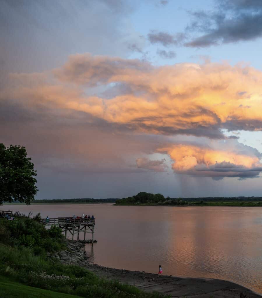 People enjoy a beautiful sunset along the shore of the Missouri River at Missouri National Recreational River.