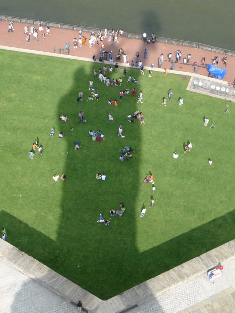 The shadow of the Statue of Liberty shrouds visitors at the National Parks of New York Harbor.