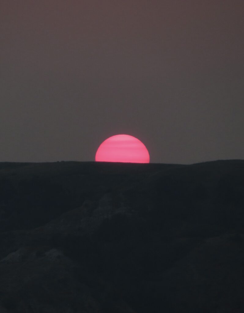 A red sun sets along the North Country National Scenic Trail, North Dakota.