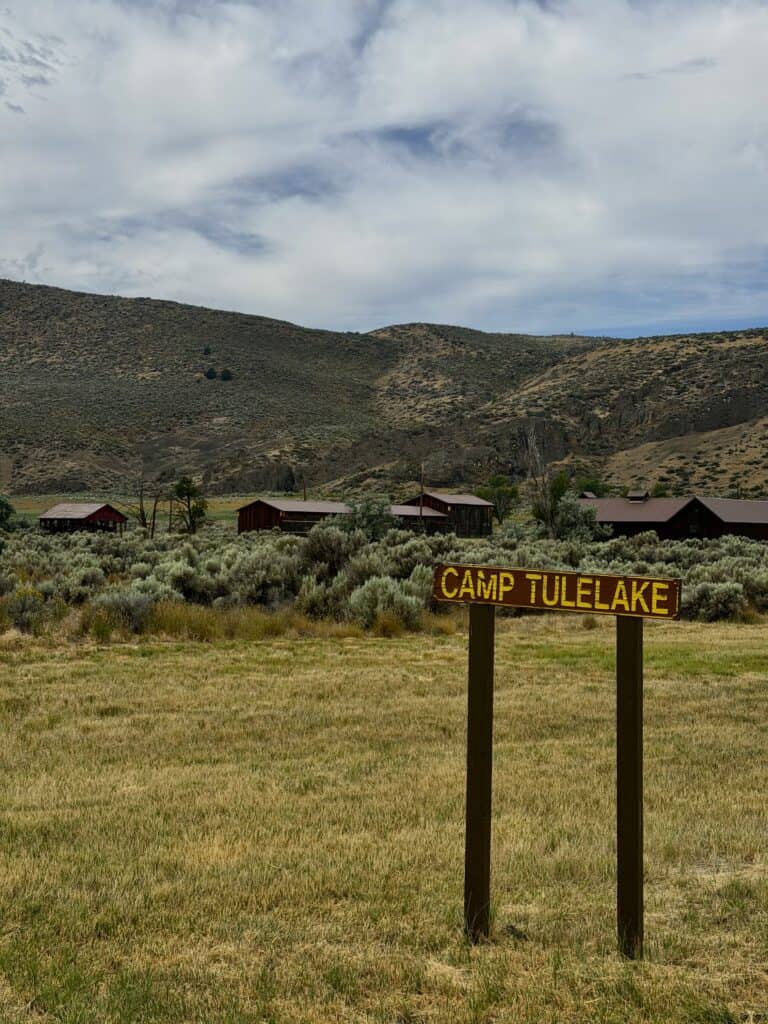 Worn-out wood buildings stand amid sagebrush at Tule Lake National Monument.