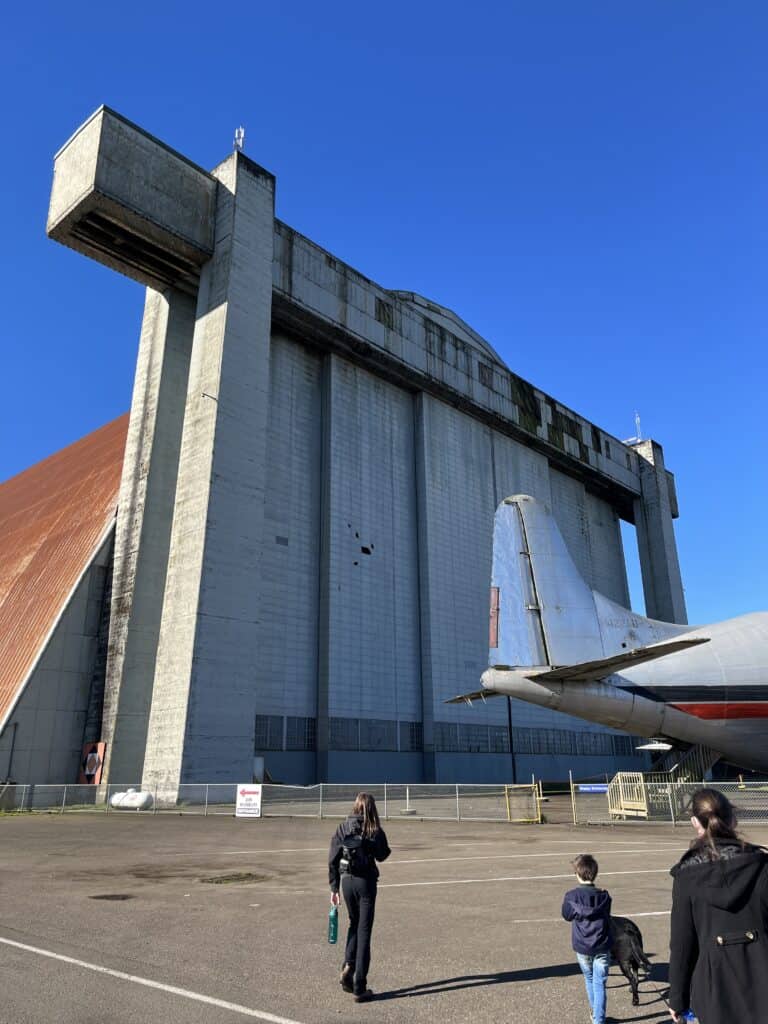 A massive derigible hangar dwarfs our family at the Tillamook Air Museum in Tillamook, Oregon.