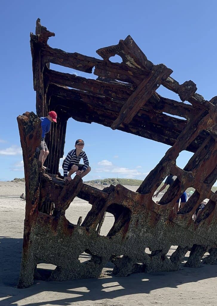 Our boys explore the rusted shipwreck of the Peter Iredale near Astoria, Oregon.