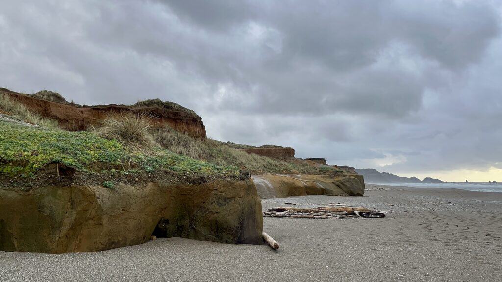 Ominous gray clouds hover over the golden bluffs of the Blacklock Cliffs.