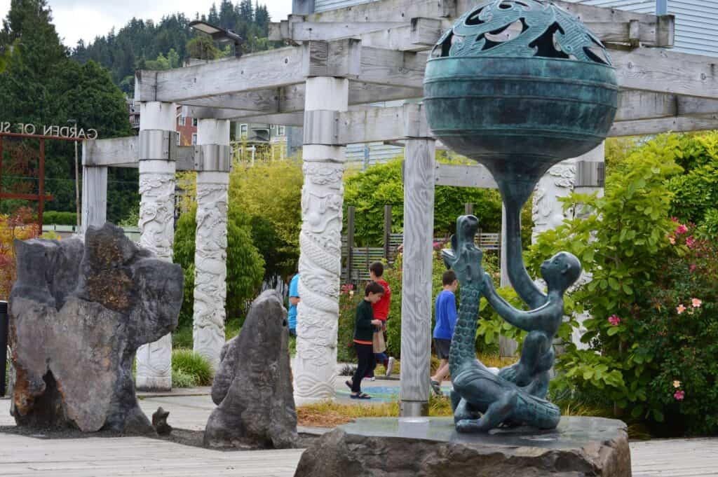 Our kids wander through the Garden of Surging Waves in Astoria.