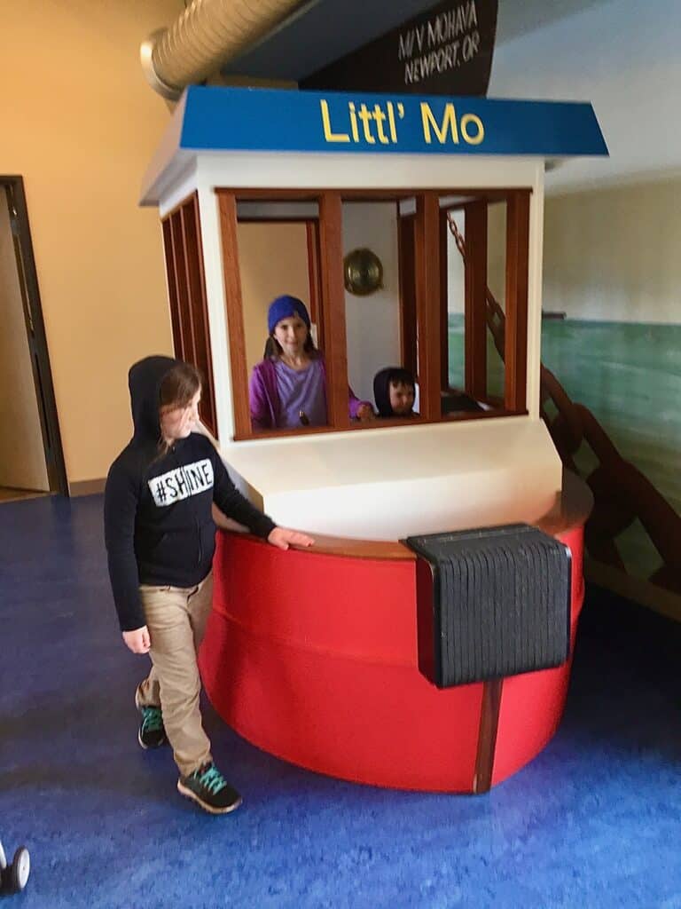 Our kids play in the pretend boat at Mo's Seafood & Chowder in Astoria. 