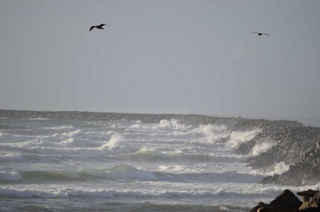 Winds blow strong tides against the breakers at the mouth of the Columbia River.