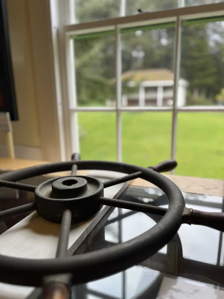 A miniature ships wheel sits on a display case at Port Orford Heads State Park in Port Orford, Oregon.