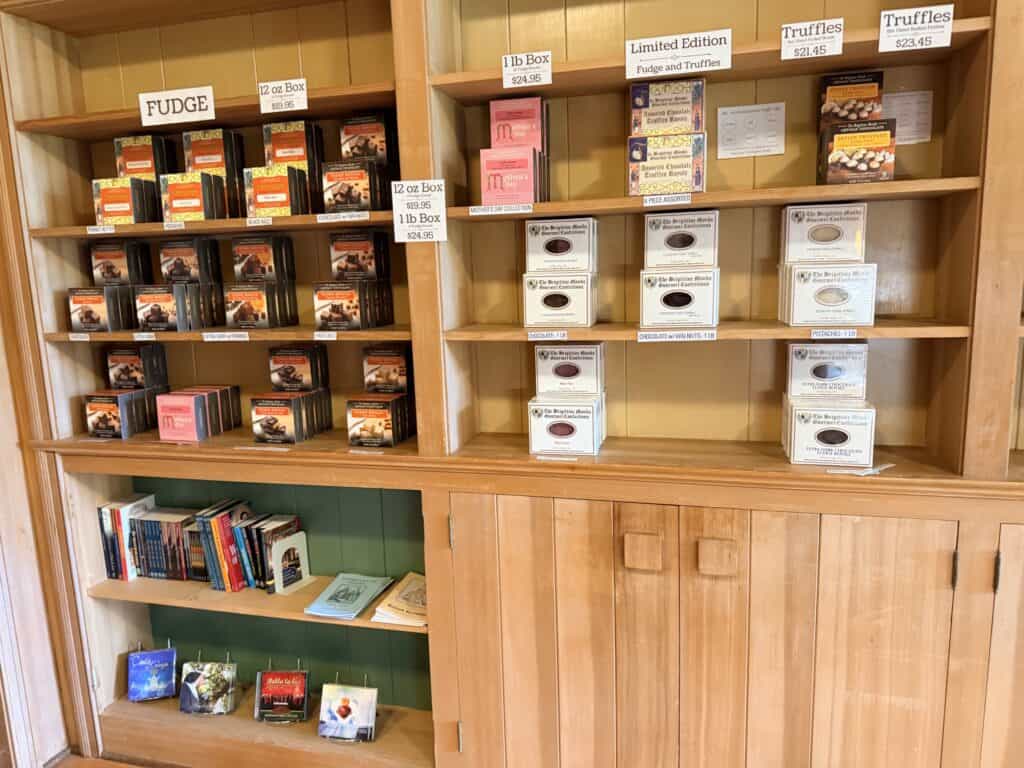 Boxes of fudge, truffles and Catholic books on shelves.