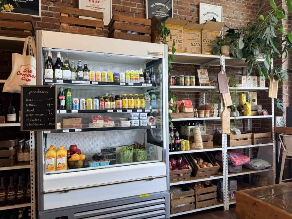Chilled case and shelves with groceries at the Common Cup Marketplace.