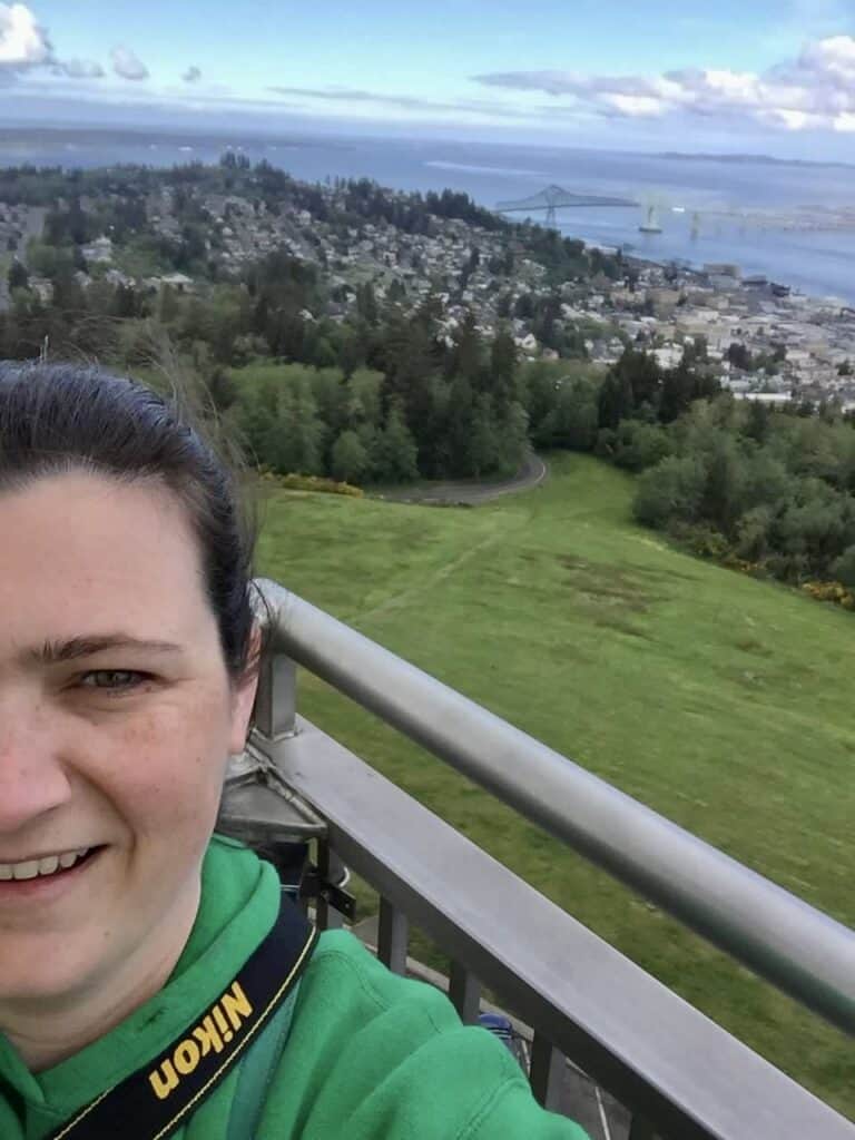 A selfie of Jennifer with a bird's-eye view of Astoria.