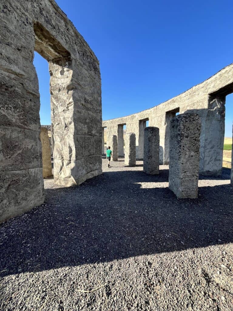 Our son is dwarfed inside the Maryhill Stonehenge.