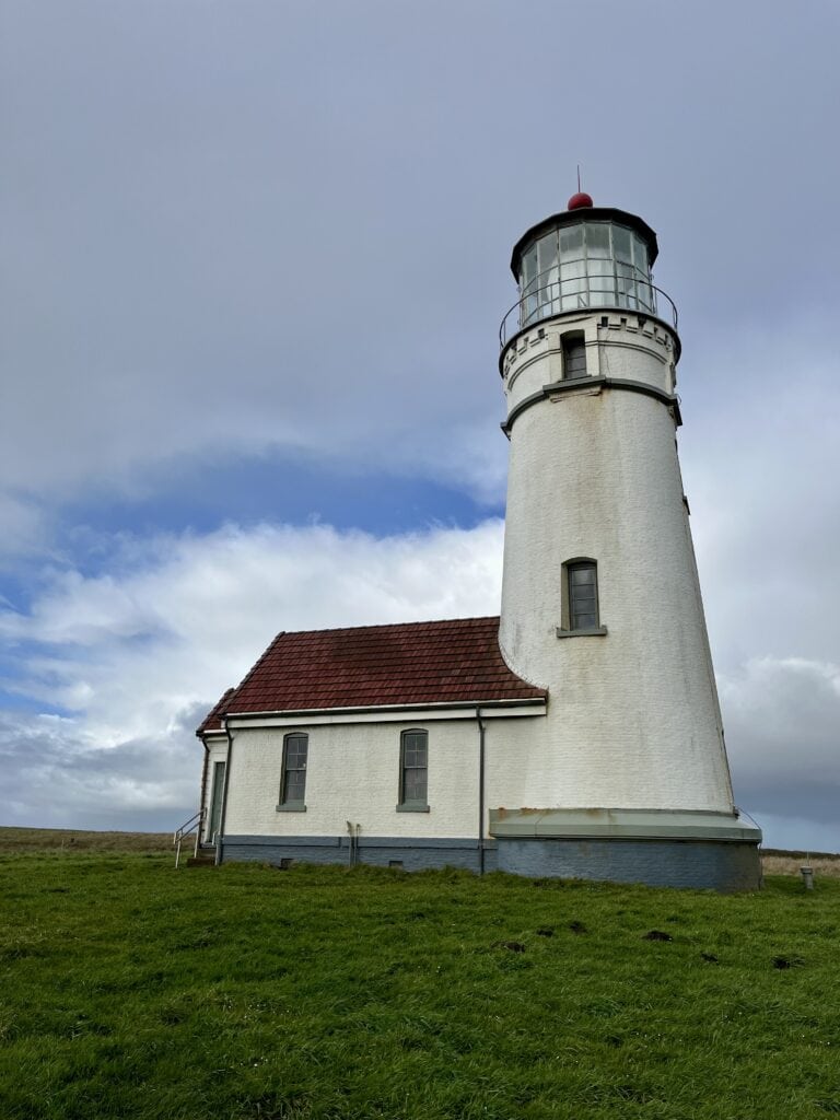 The historic Cape Blanco Lighthouse stands on verdant glade at Cape Blanco State Park.