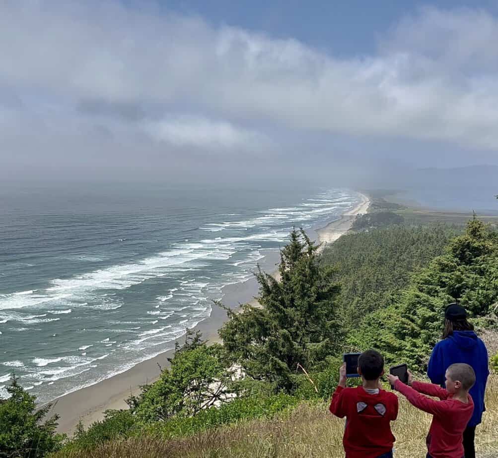 Our boys take pictures of the dramatic view from Cape Lookout State Park.