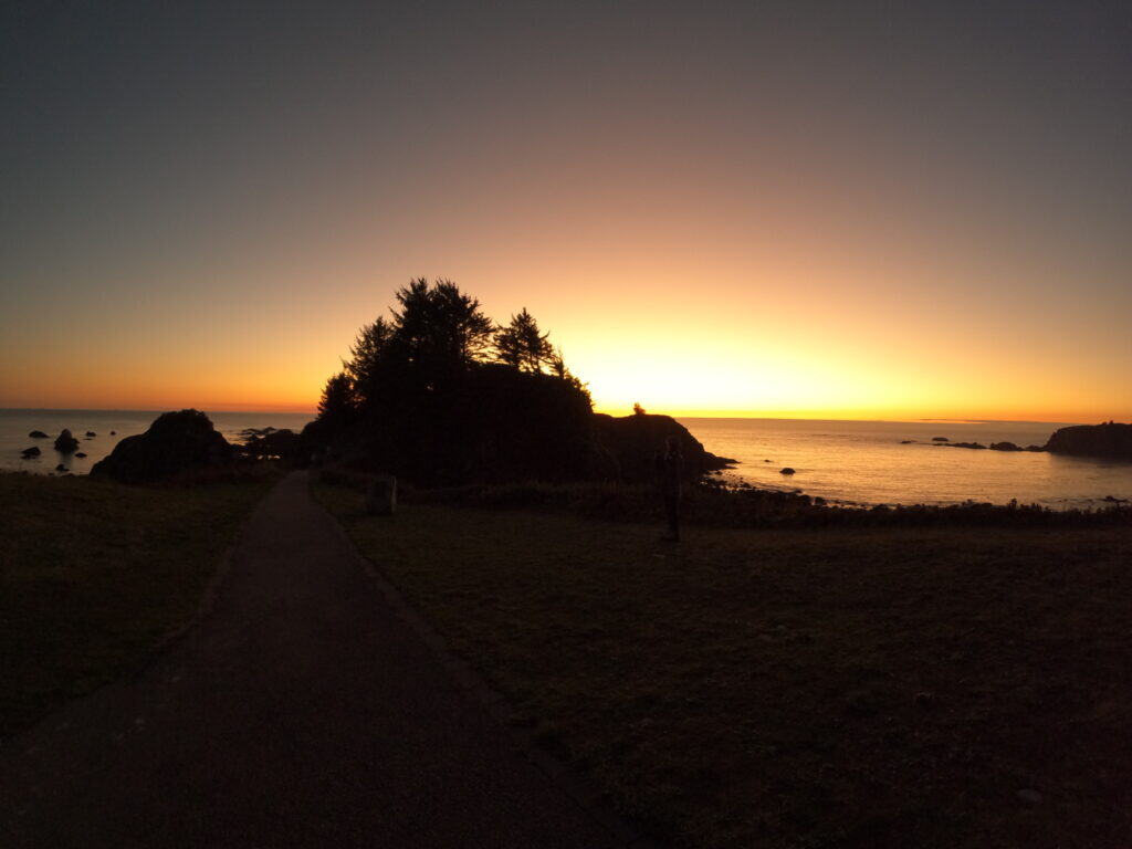 Chetco Point stands in silhouette to the sunset in Brookings, Oregon.
