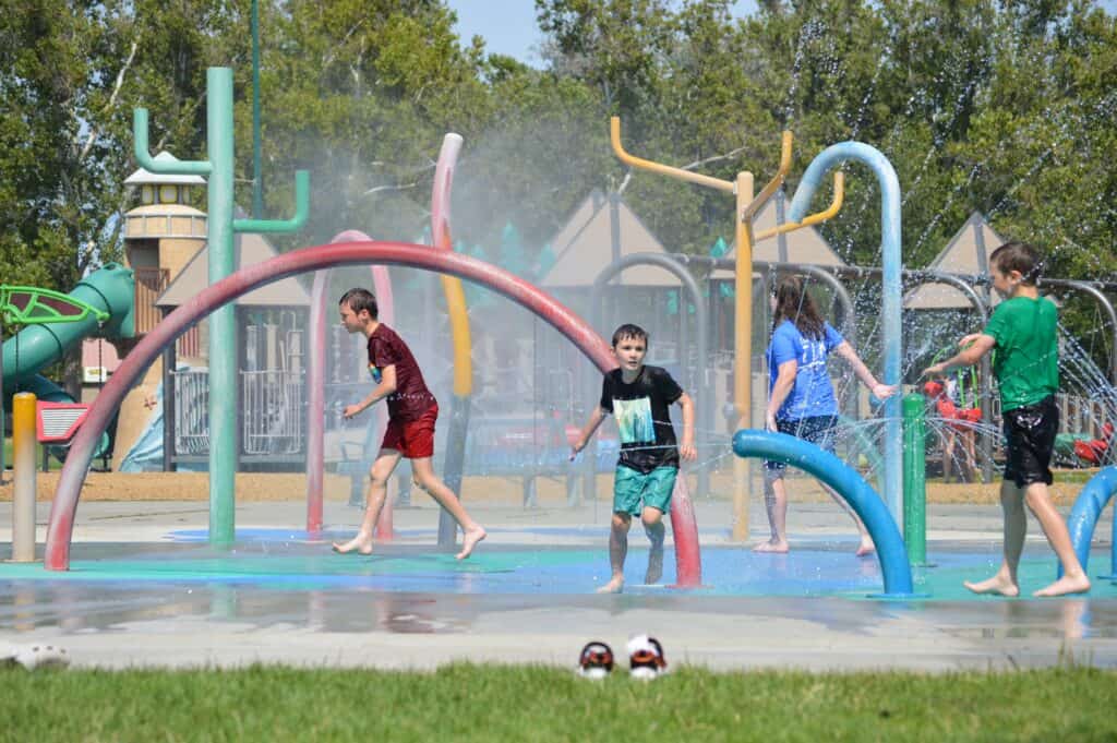 Our four kids run around at the splash pad at the Playground of Dreams in Kennewick.