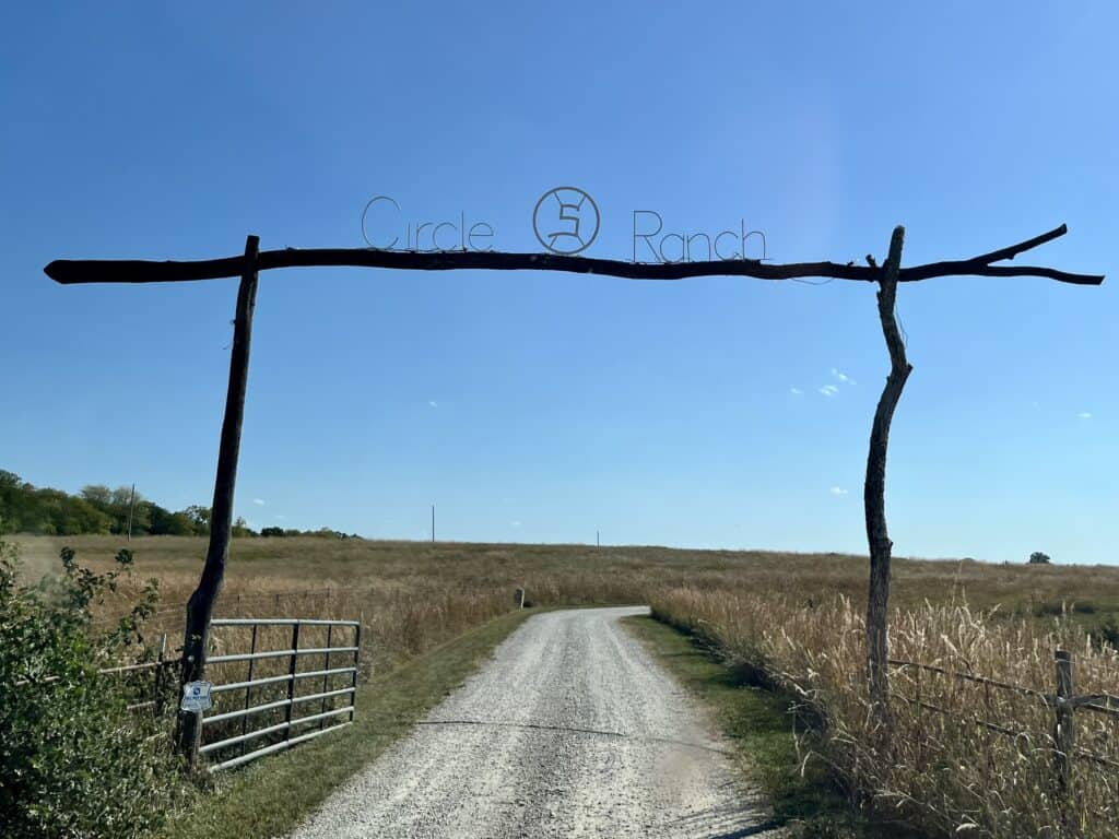 Rustic wooden gate with Circle S Ranch sign.