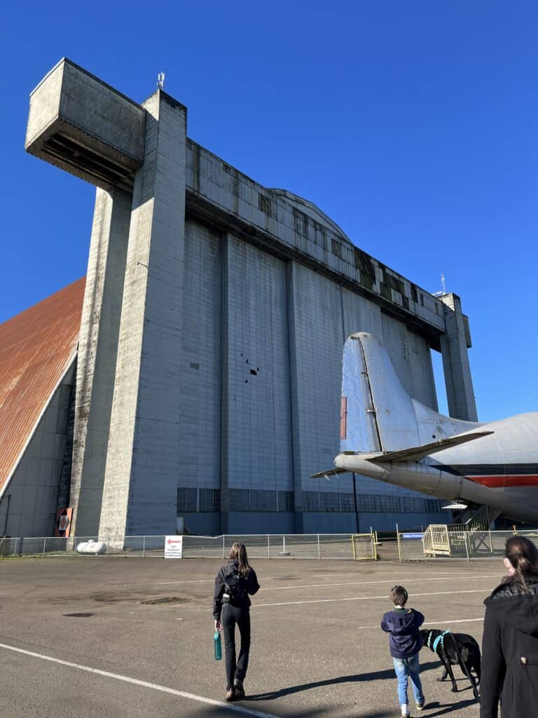 Hangar B towers over our children at the Tillamook Air Museaum in Tillamook, Oregon.
