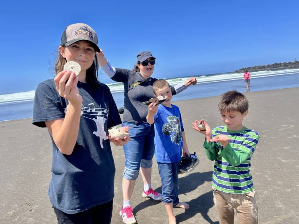 Our children show the sand dollars and shells that they found while beachcombing at Nedonna Beach.