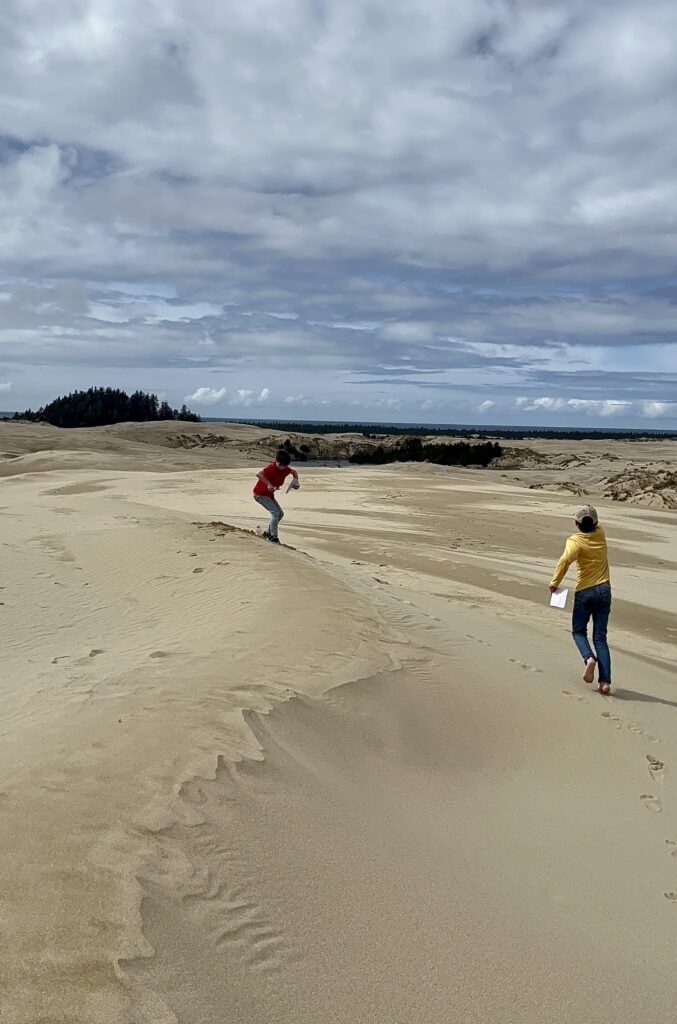 Our boys run along the top of a dune at the Oregon Dunes in Florence.