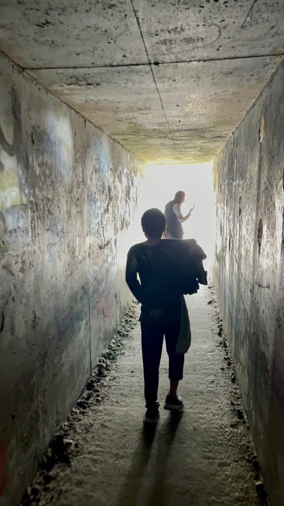 Our kids explore the tunnel from which Tunnel Beach gets its name.