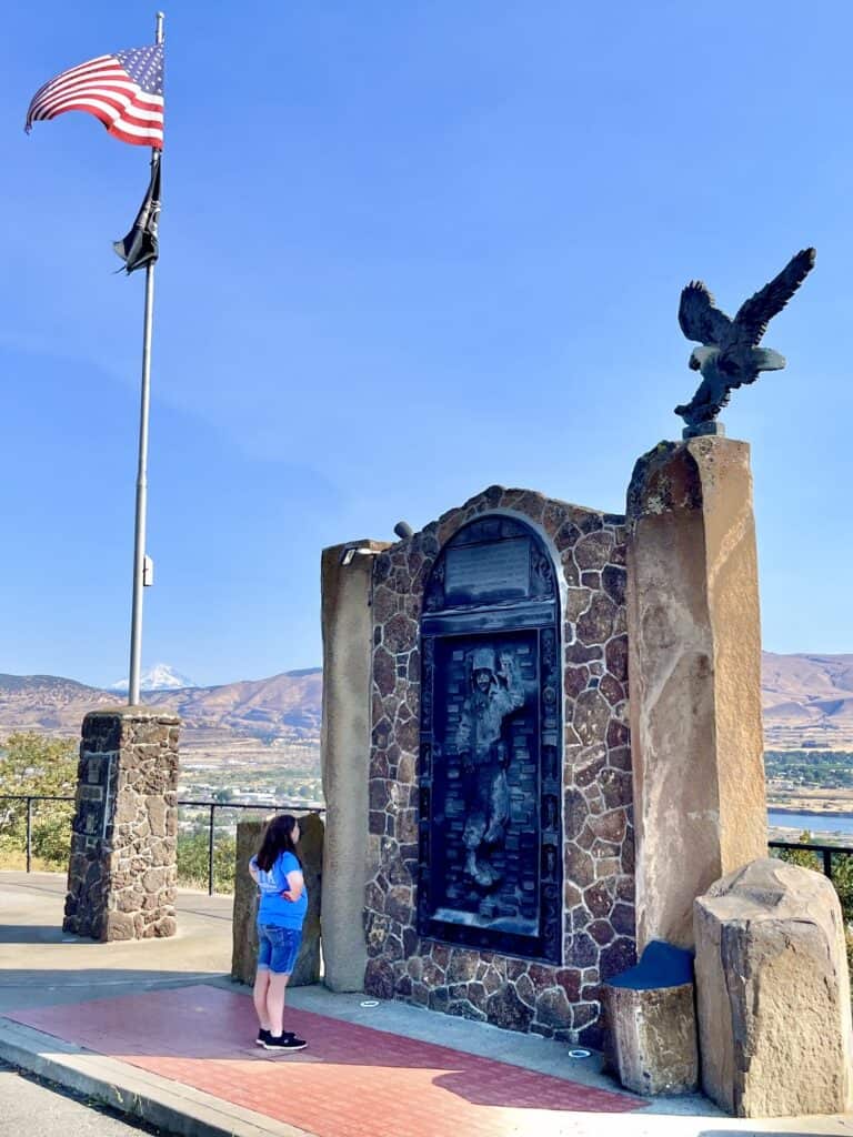 Our daughter reads a sign at the Veterans Memorial overlooking The Dalles at Sorosis Park.