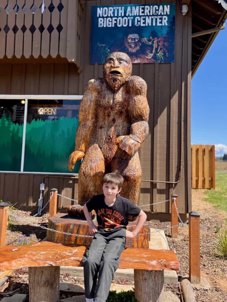 Our son gets a photo with the wooden Sasquatch.