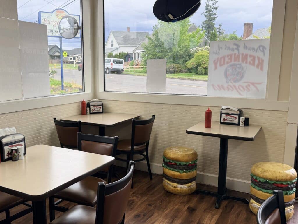 Dining room at Burger Time with burger stools at a table.