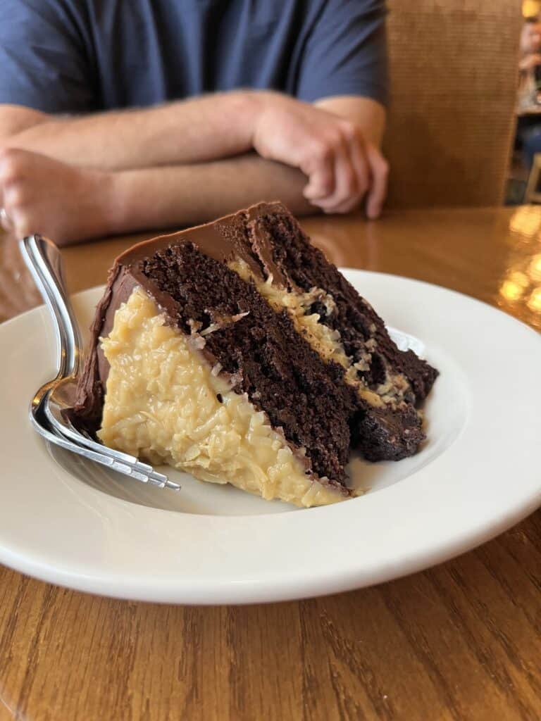 German Chocolate cake slice on a white plate.